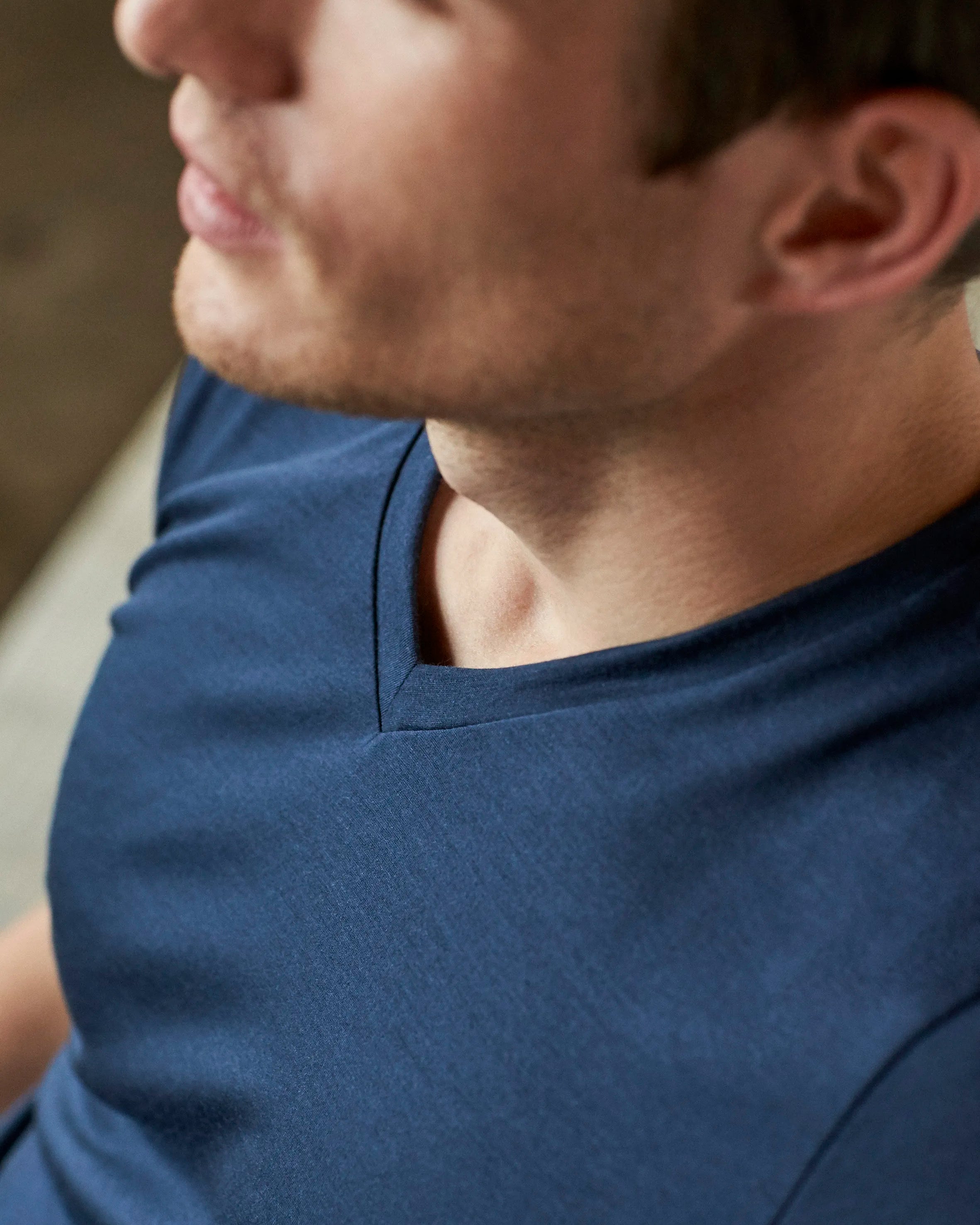 Detail shot of the navy V neck collar from Wolk's men's merino wool T-shirt collection.