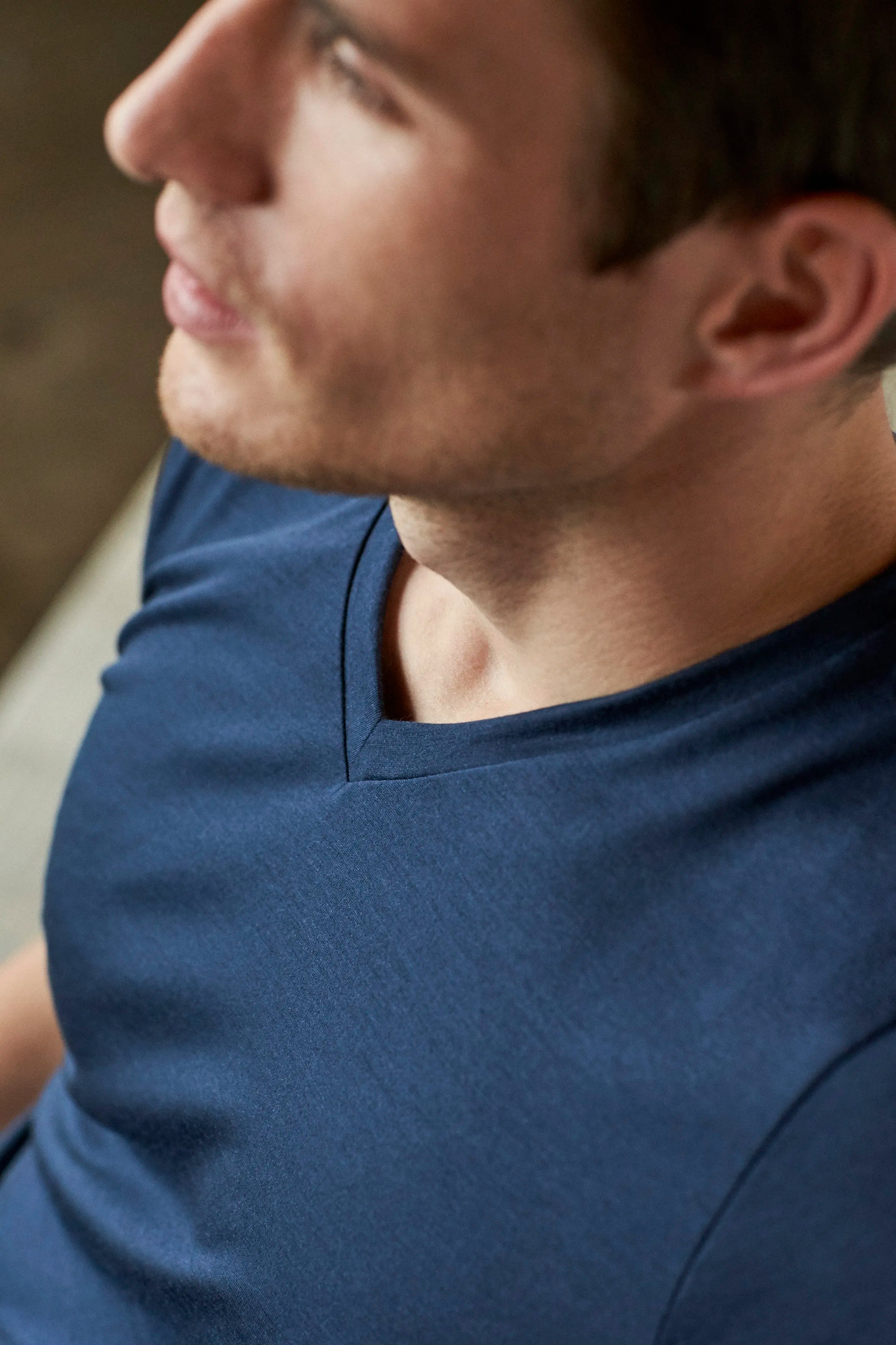 Detail shot of the navy V neck collar from Wolk's men's merino wool T-shirt collection.