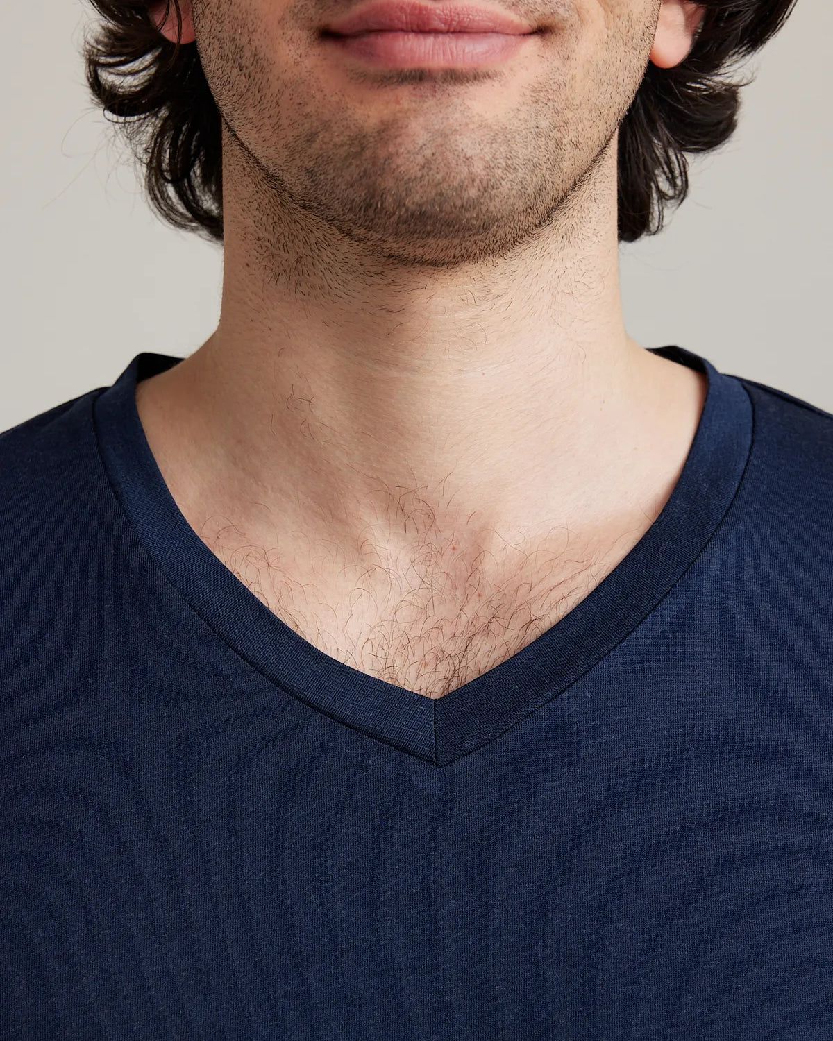 Detail shot of the navy V neck collar from Wolk's men's merino wool T-shirt collection.