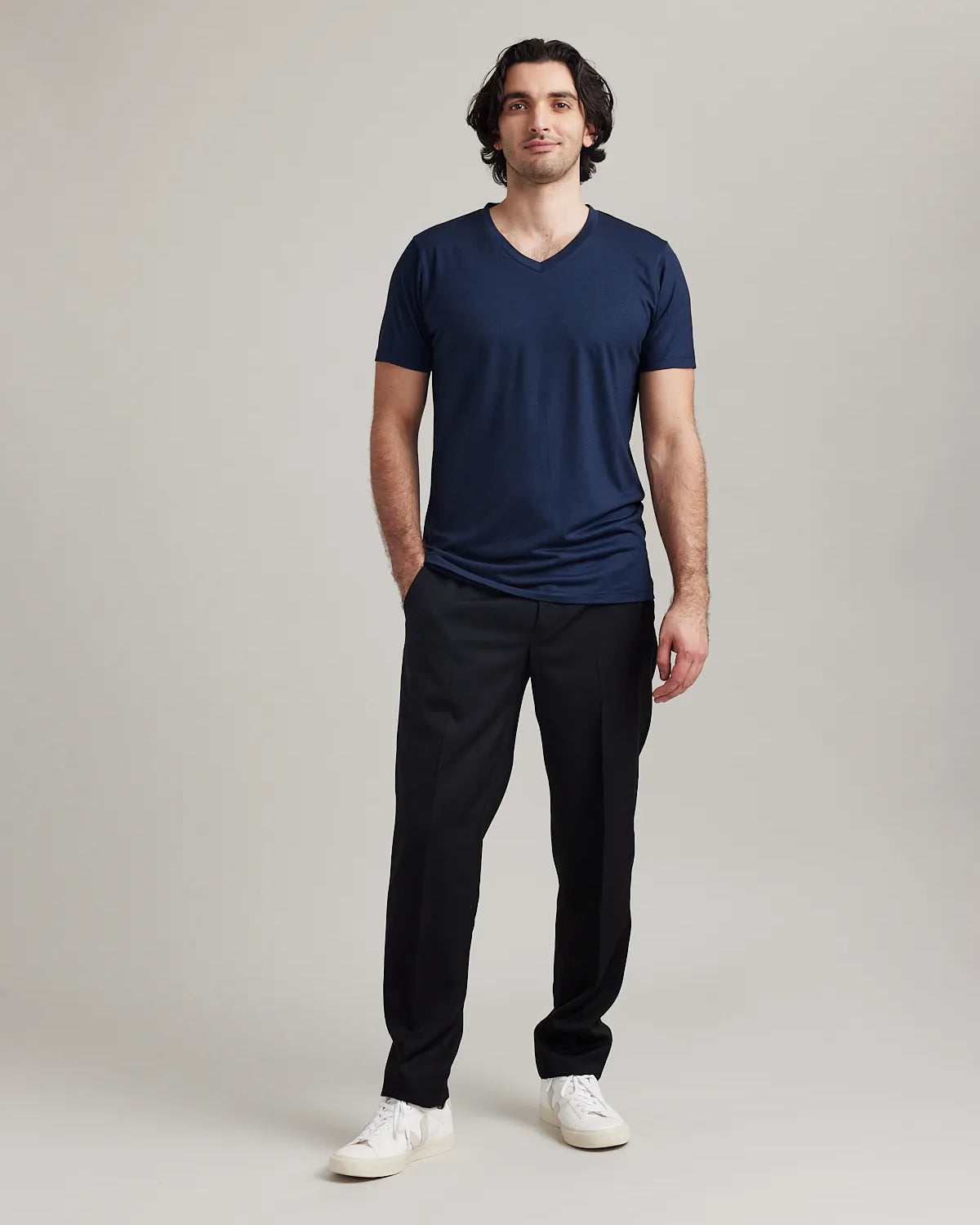 Wolk's navy men's merino wool T-shirt in a studio setting, showcasing V-neck design.
