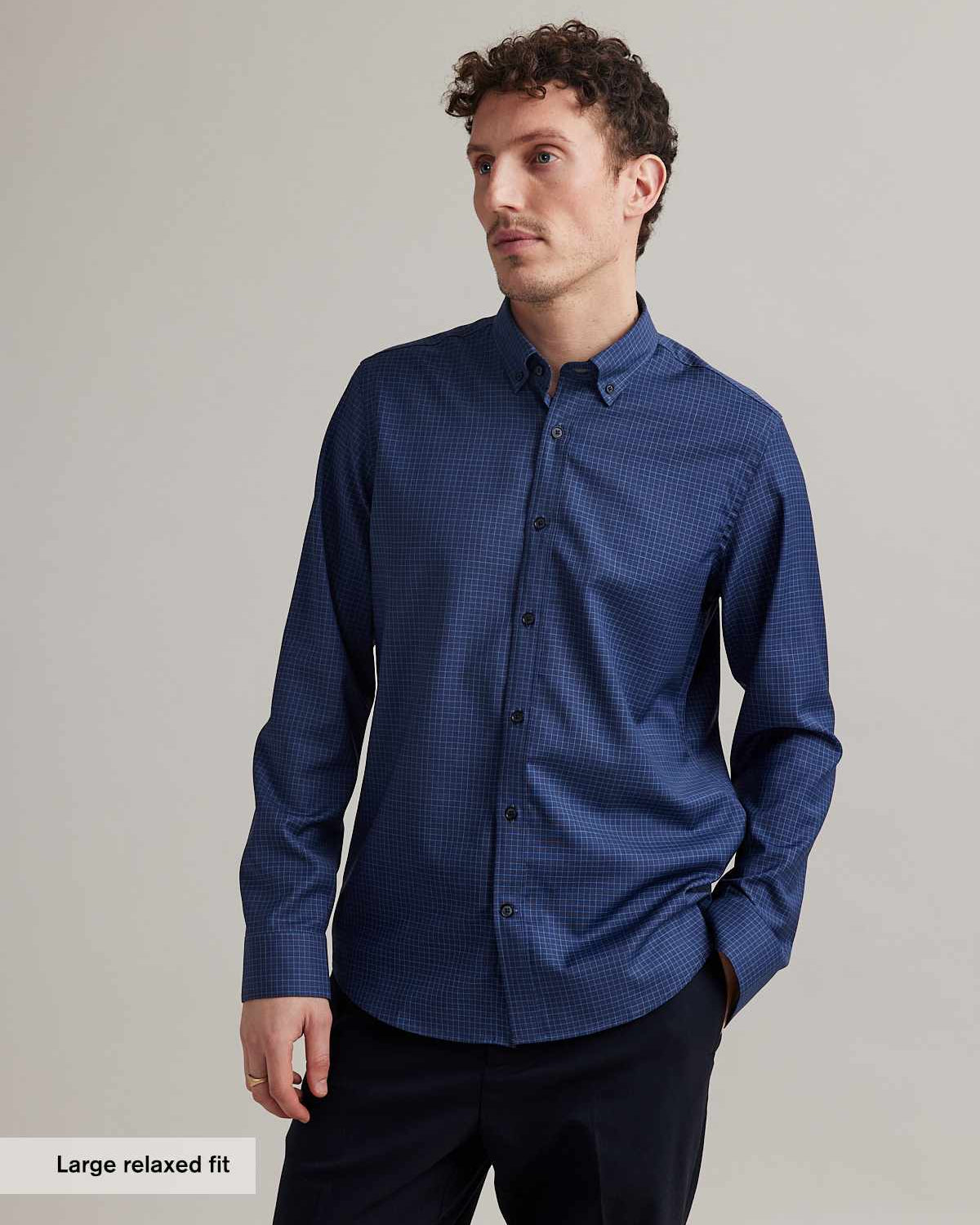 man wearing merino shirt in blue color with small graph check and button down collar in relaxed fit from Wolk