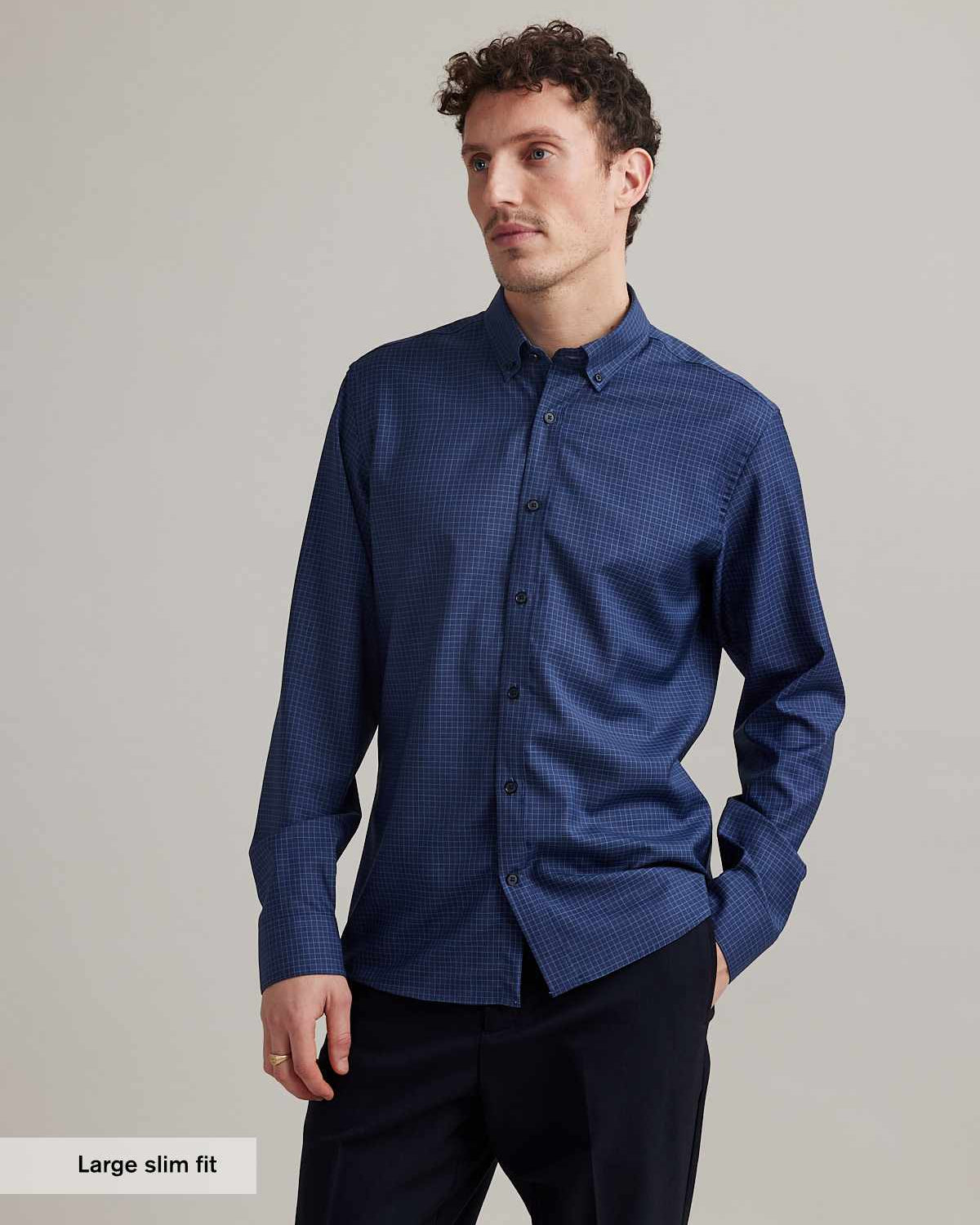 man wears Wolk merino shirt in blue color with small graph check and button down collar in slim fit