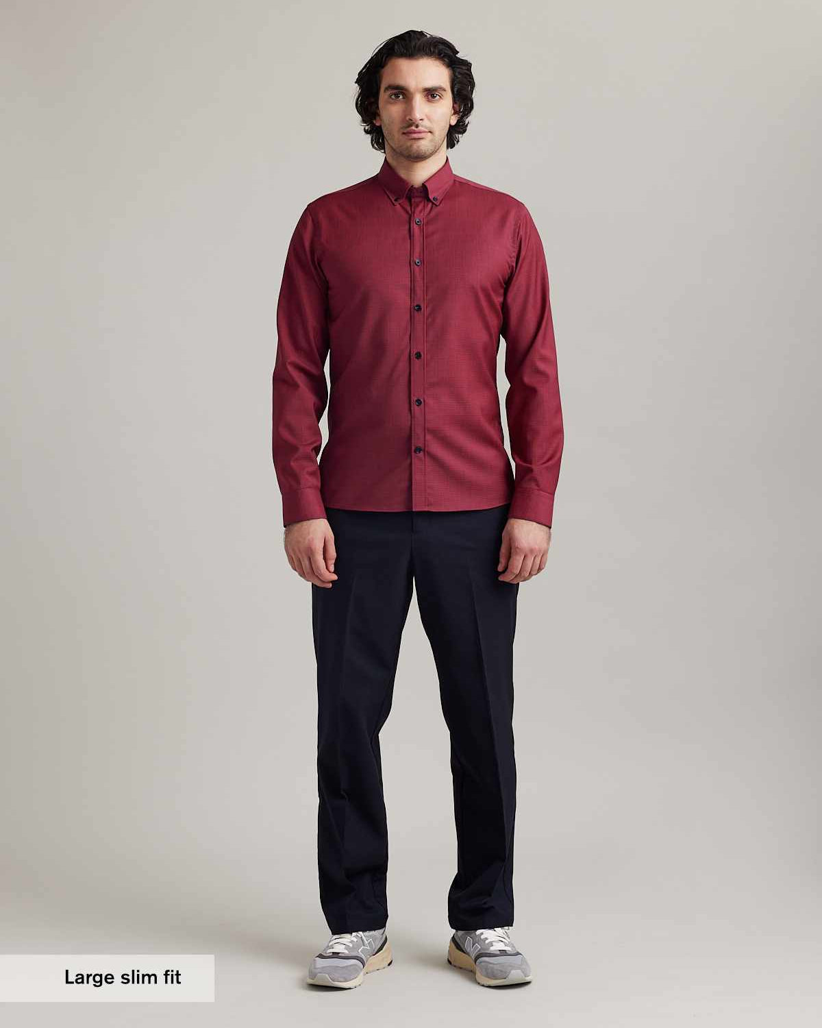 Men wears a merino wool shirt from wolk on red navy mini gingham with button down collar and navy buttons in slim fit and long sleeves
