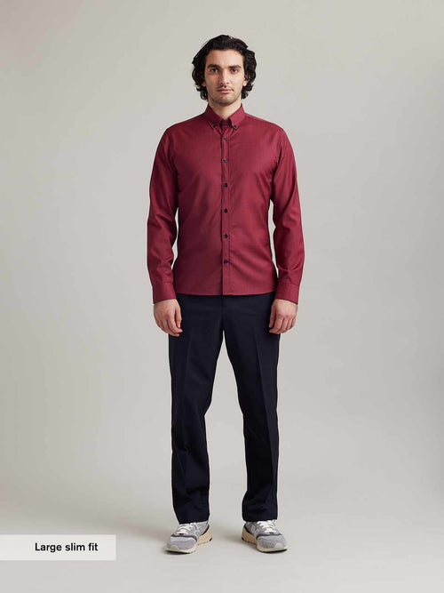 Men wears a merino wool shirt from wolk on red navy mini gingham with button down collar and navy buttons in slim fit and long sleeves
