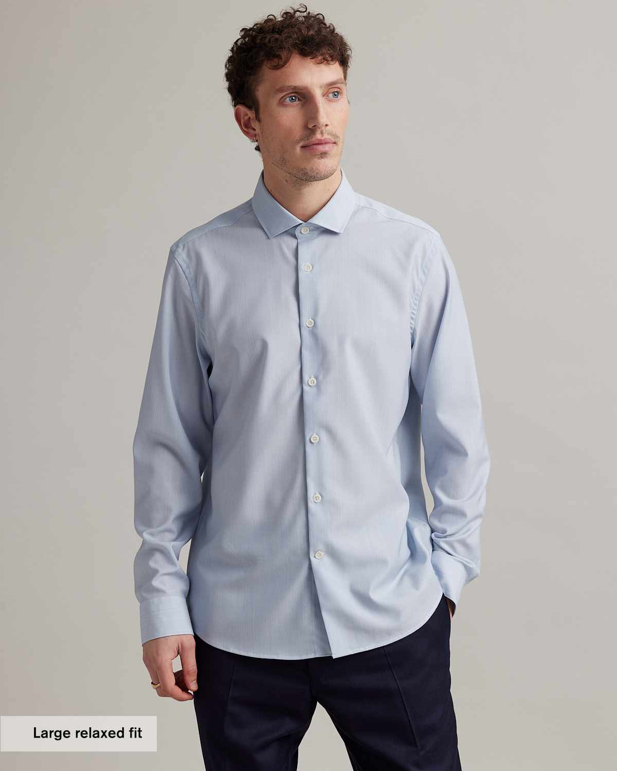 man wearing light blue merino shirt with spread collar in relaxed fit