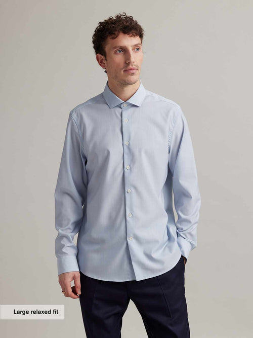 man wearing light blue merino shirt with spread collar in relaxed fit