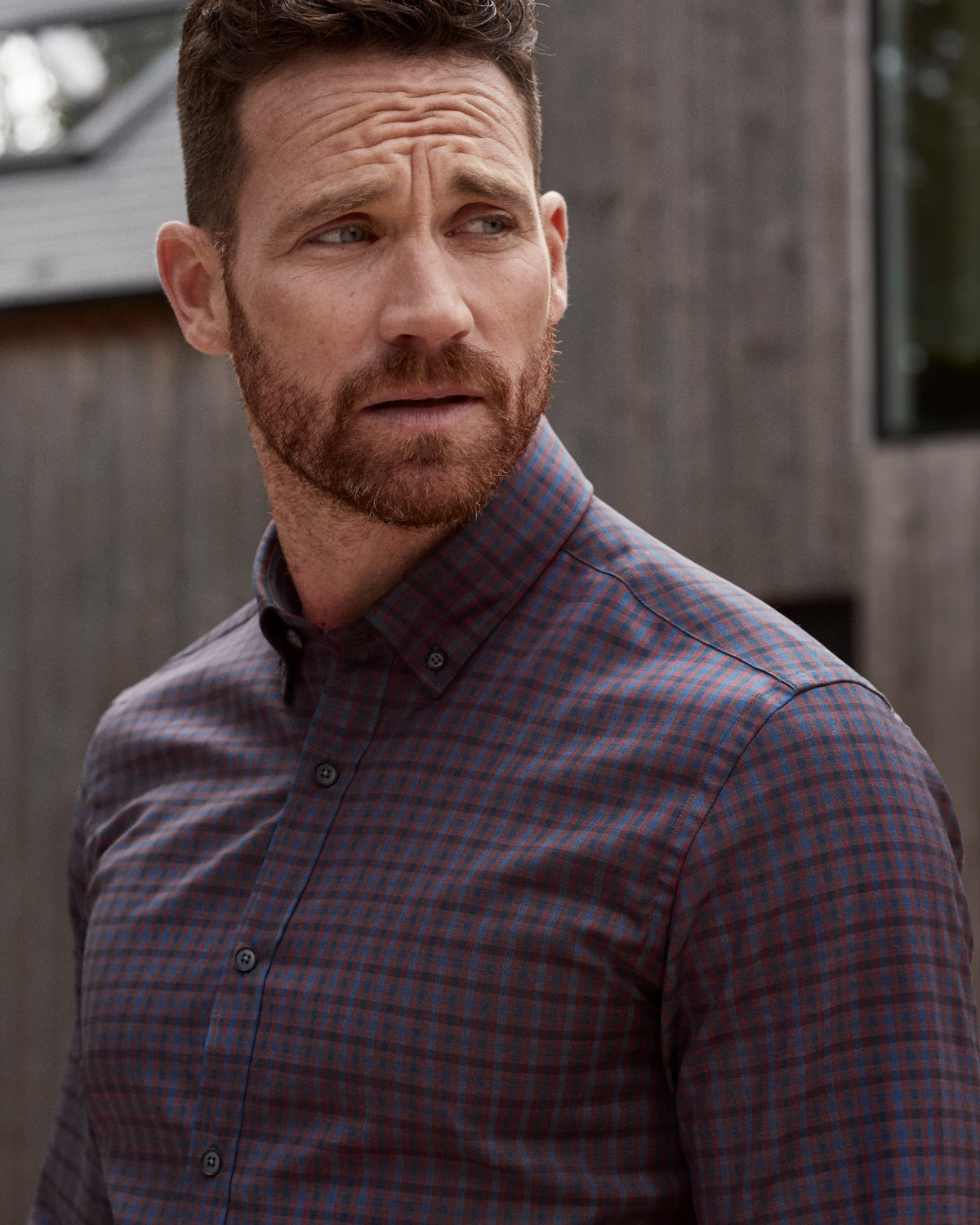 Man wearing burgundy navy check button down in merino wool