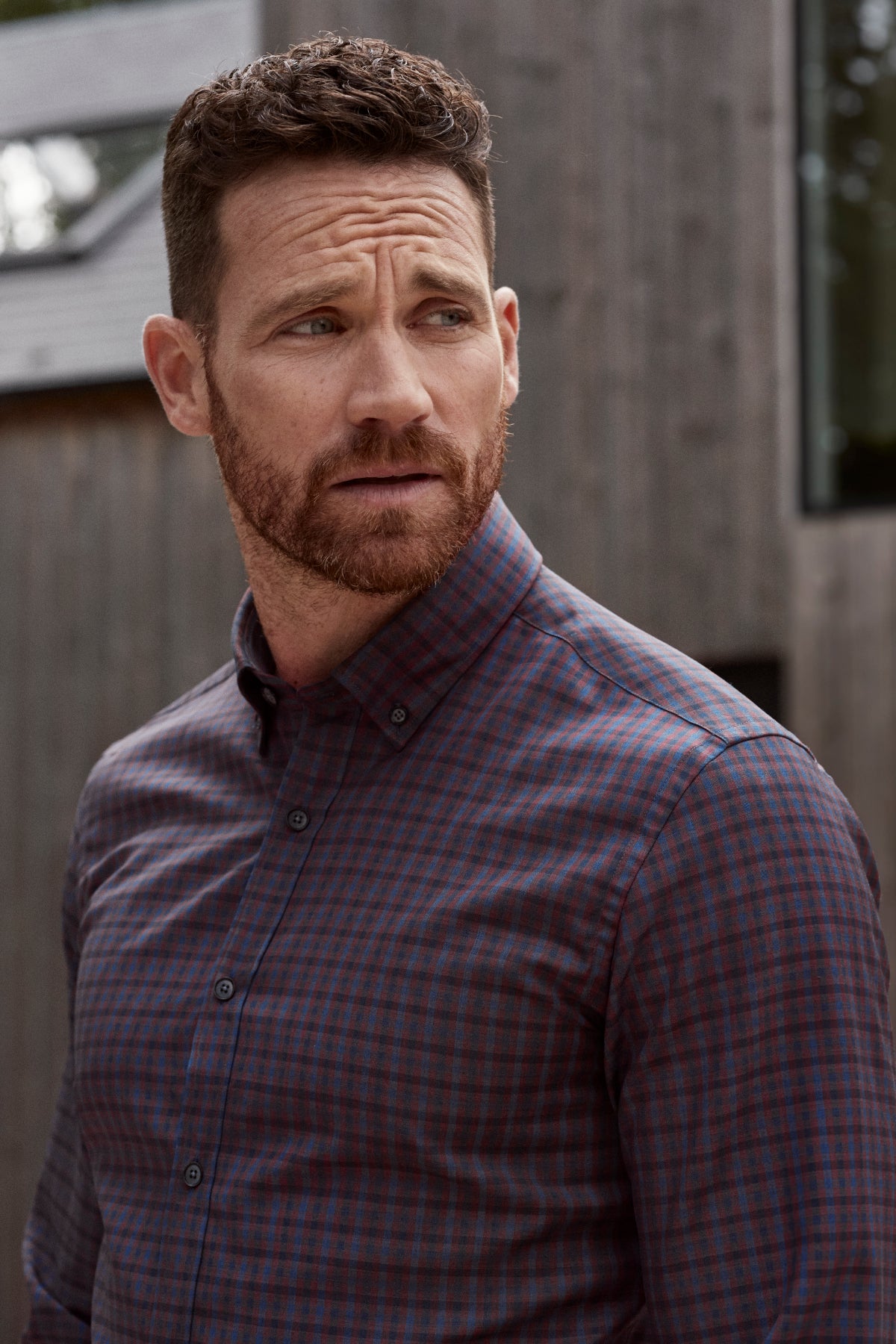 Man wearing burgundy navy check button down in merino wool