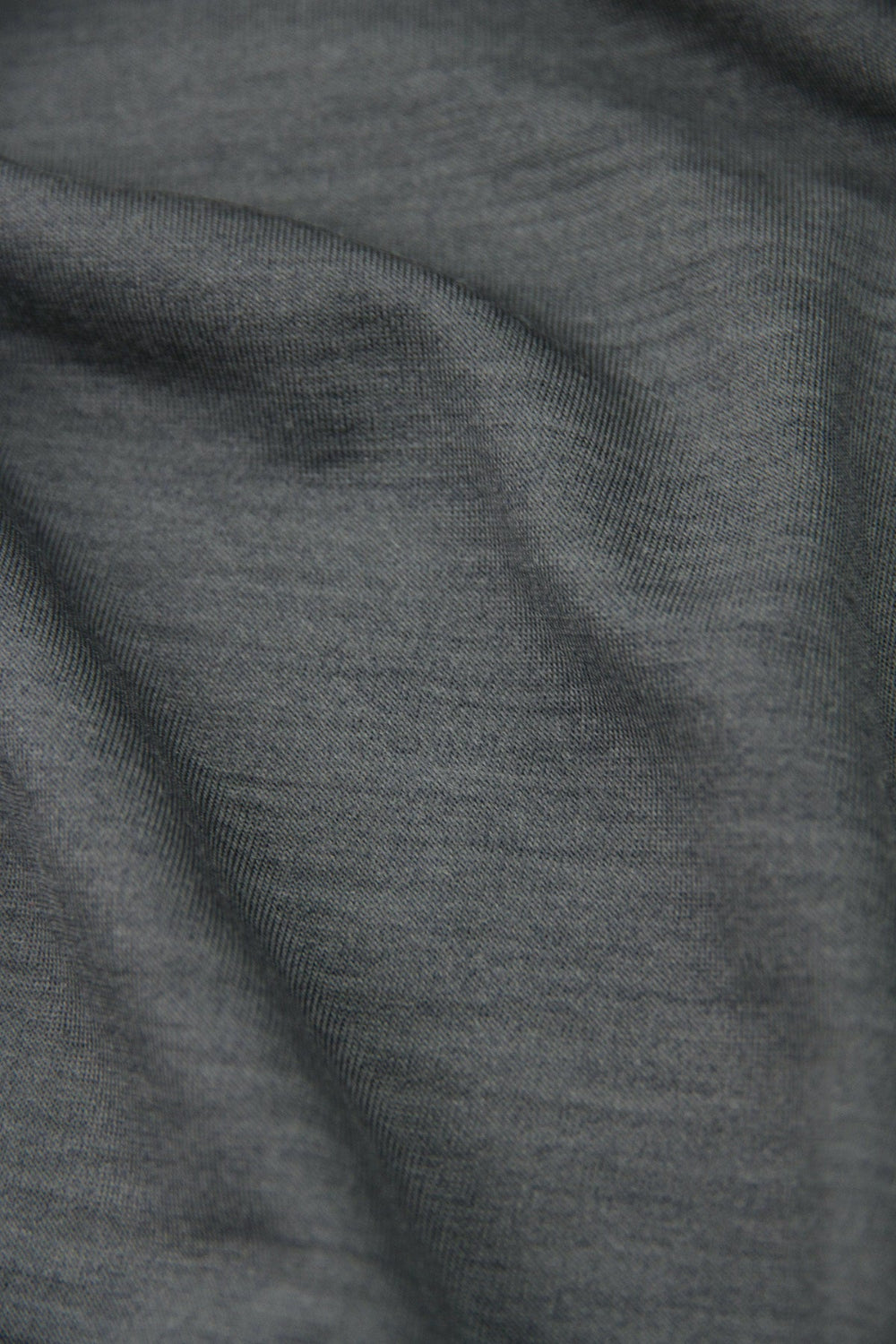 Close-up of dark gray merinowool fabric with visible jersey texture