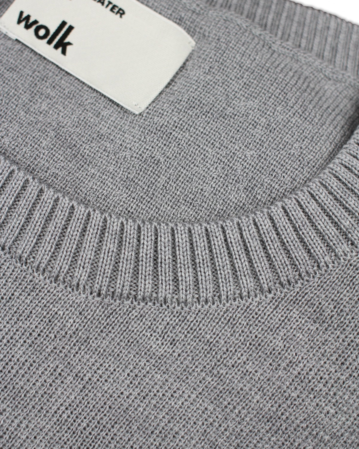 Wolk label on merino wool sweater in light grey melange color