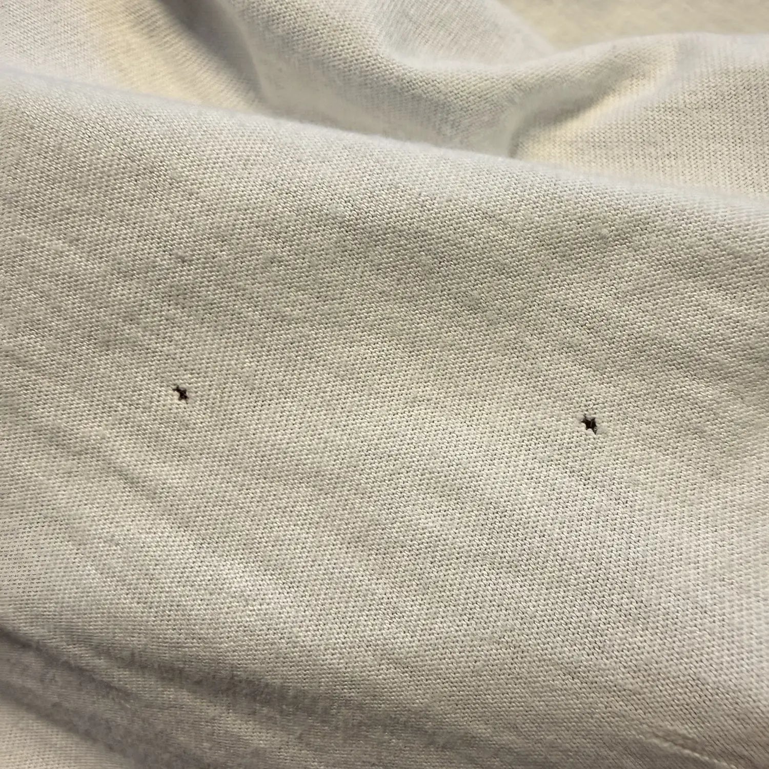 Where do mystery holes in T-shirts come from? And why merino gets them first