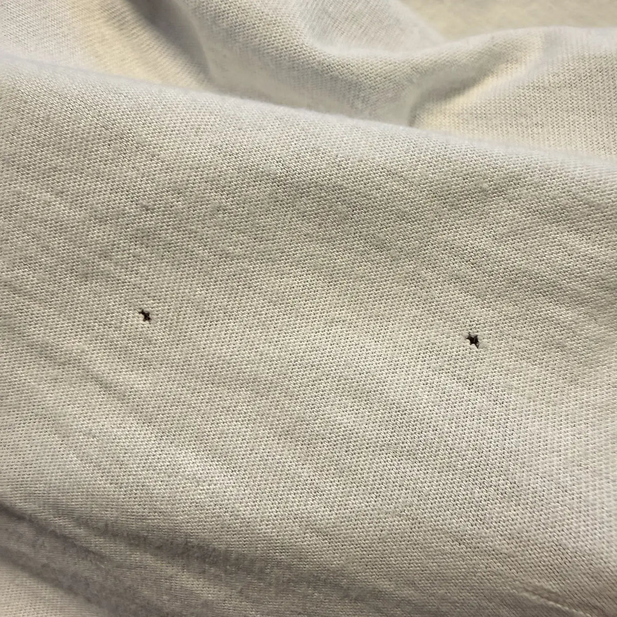 Where do mystery holes in T-shirts come from? And why merino gets them first