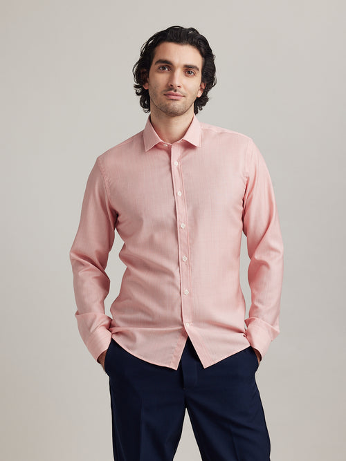 Man wears a merino wool shirt from Wolk in red hairline stripe with white buttons and classic collar in slim fit