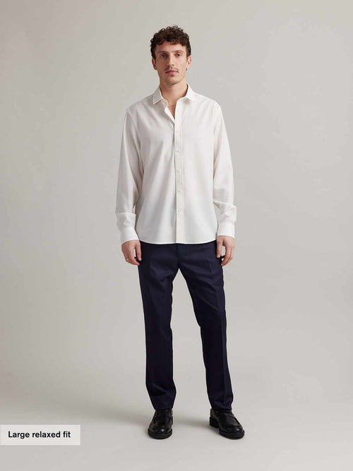 Man wearing a long sleeve merino dress shirt in white and relaxed fit