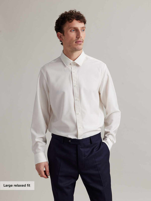 Man wearing a long sleeve merino dress shirt from Wolk in white with classic collar and white buttons in relaxed fit