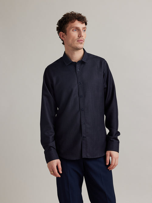 Man wearing a denim merino wool shirt in dark navy color