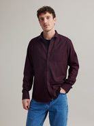 Man wearing navy red gingham flannel merino wool shirt with chest pocket