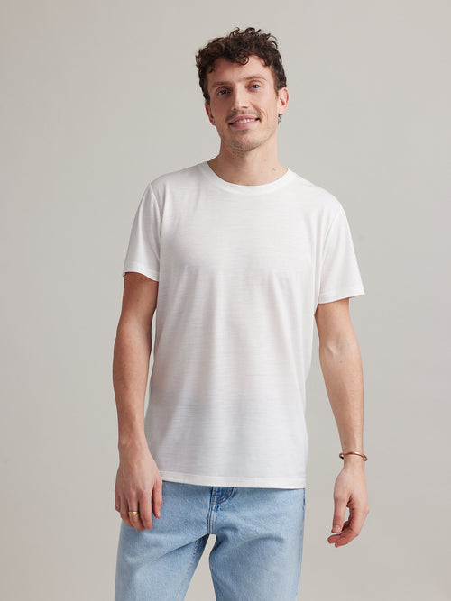 Man wearing white merino wool T-shirt with round neck and short sleeves made in Europe