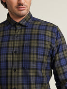 Close up of merino wool flannel shirt with chest pocket in green navy check pattern