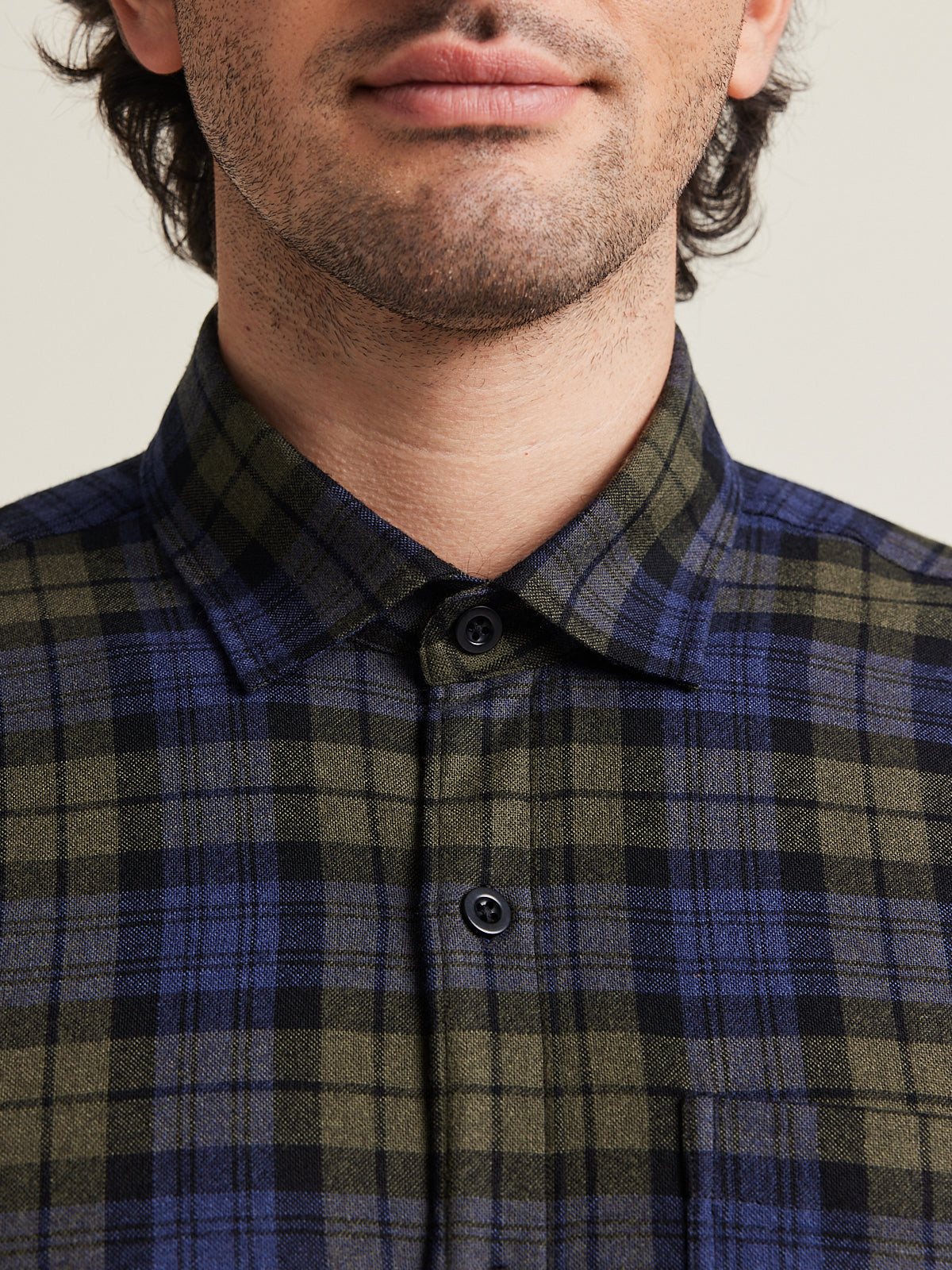 Close up of merino wool flannel shirt in blue green check pattern with blue corozo buttons from Wolk 
