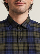 Close up of merino wool flannel shirt in blue green check pattern with blue corozo buttons from Wolk 