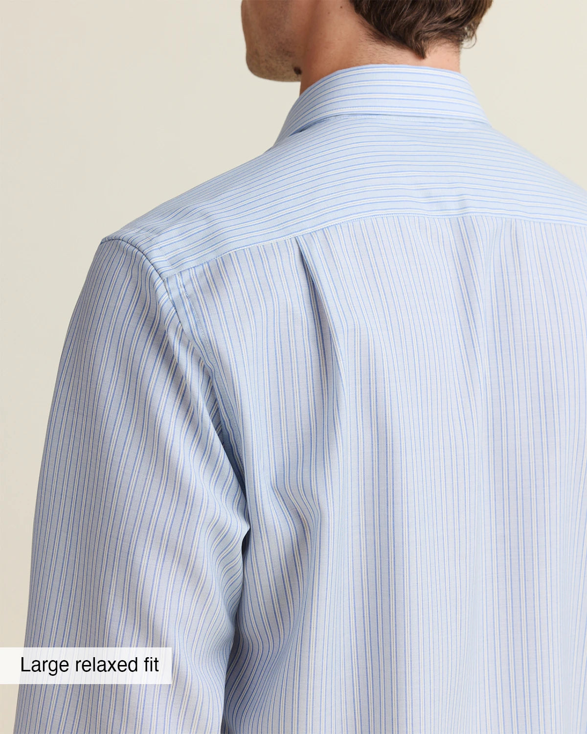 close up of the backside of the shoulder of a person wearing a light blue white striped merino shirt from Wolk