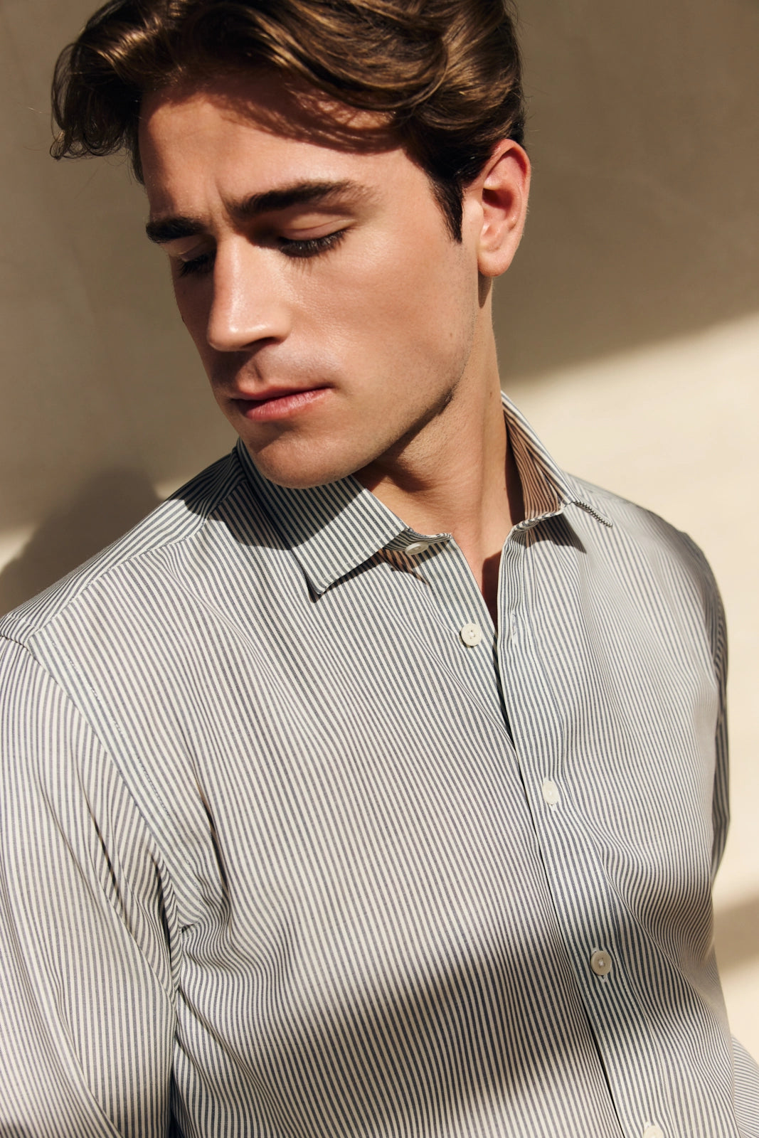 close up of a man wearing a navy bengal stripe merino wool shirt with classic collar from Wolk