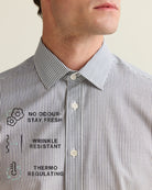 Close-up of a striped shirt with text on describing the no odour, no wrinkle and thermoregulating benefits of merino wool, on a neutral background