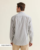 Back view of a man wearing anavy bengal striped merino shirt on a beige pants in relaxed fit from Wolk