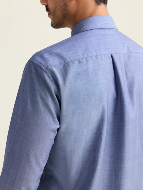Backside view of pleat on merino wool shirt in light blue denim color 