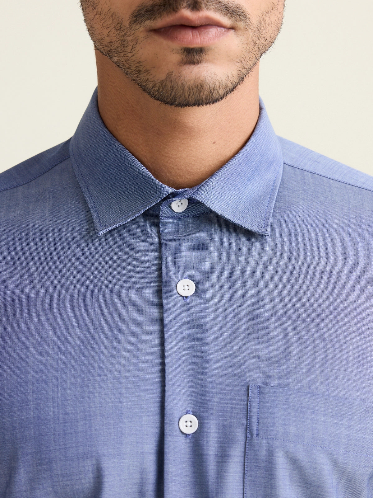 Close up of collar on light denim colored merino wool shirt with classic collar and chestpocket