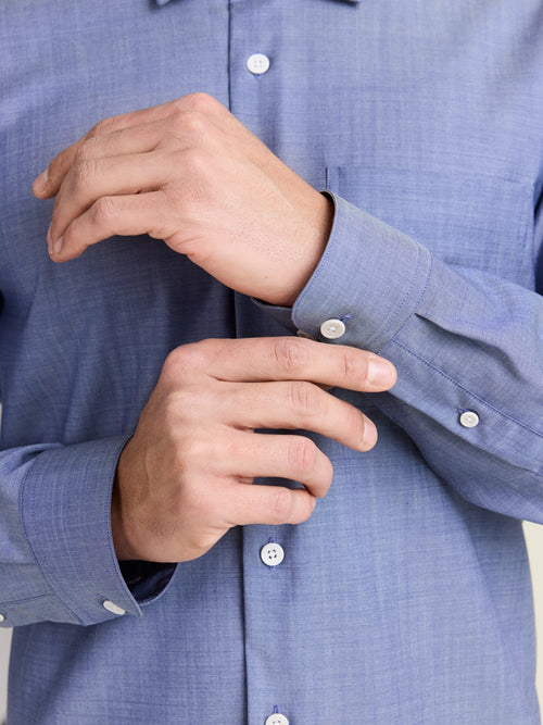 Cuff details of long sleeve merino wool shirt for men in light blue denim color with white corozo buttons