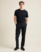 model in studio wearing a black merino tshirt on black trousers