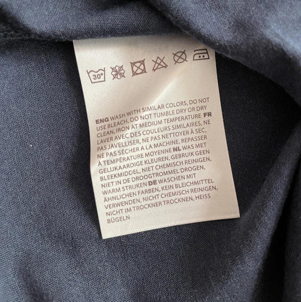 Merino wool Clothing label with care instructions on a dark fabric background