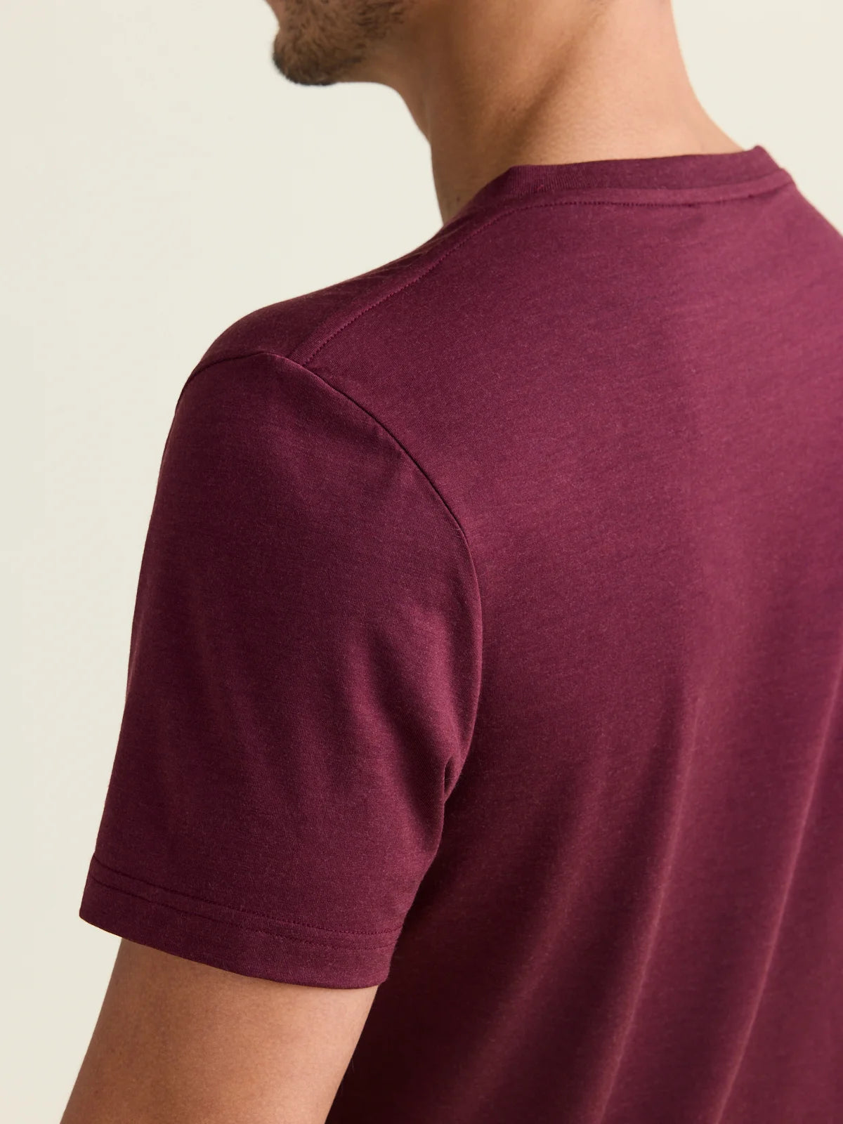 Shoulder detail of merino wool T-shirt in burgundy red color with short sleeves