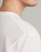 Shoulder seam on a white merino wool T-shirt from Wolk