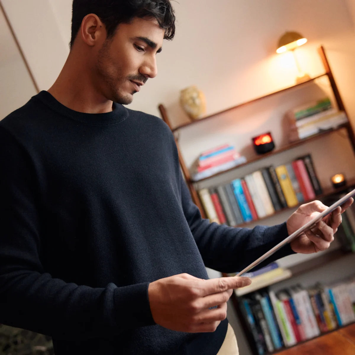 Man wearing a navy merino wool sweater from Wolk