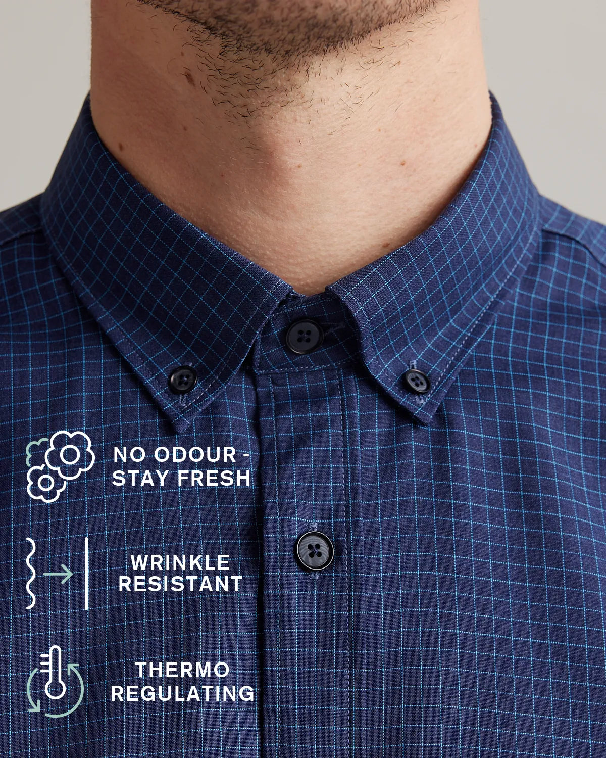 Blue checkered merino wool shirt with text on features showing no odour-stay fresh, wrinkle-resistant and thermo-regulating