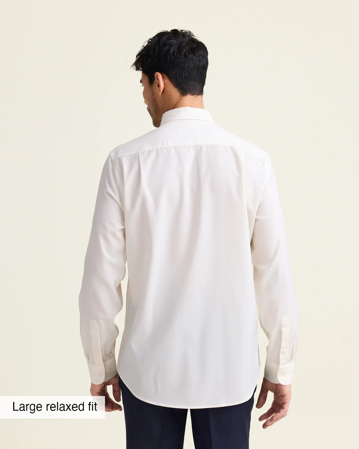 Man wearing a white merinowool dress shirt from in relaxed showing the untucked back of the shirt