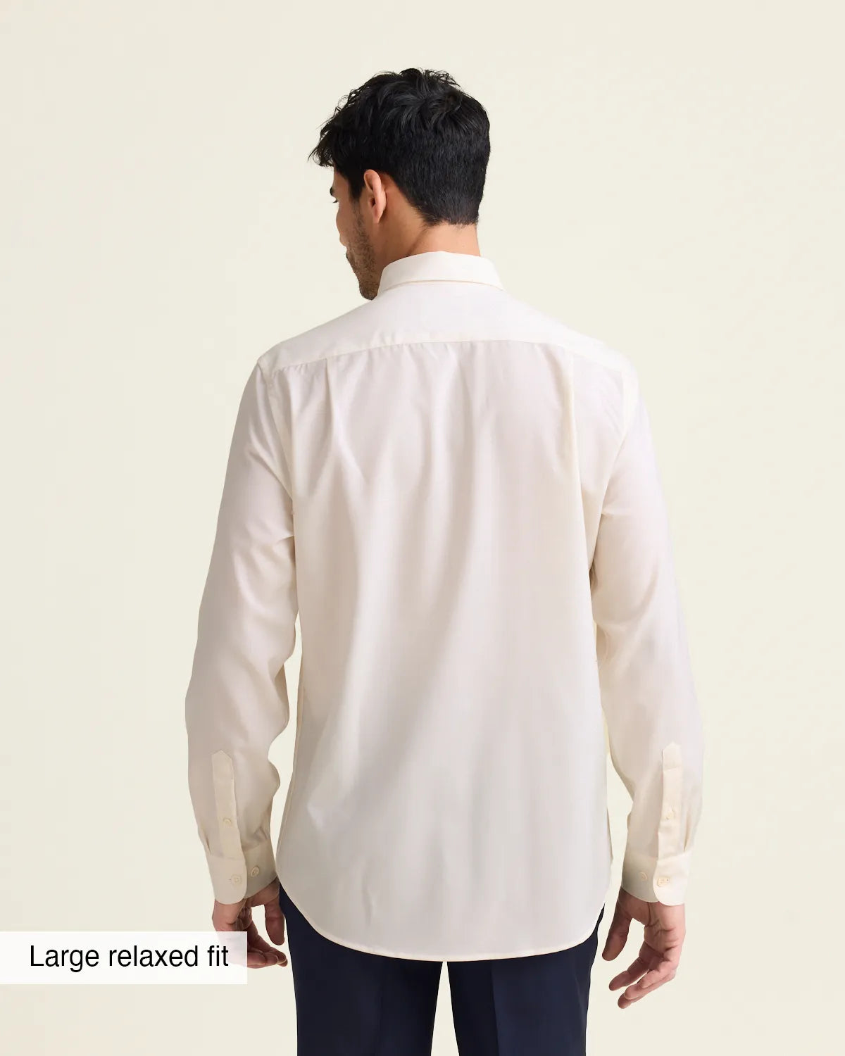 Man wearing a white merinowool dress shirt from in relaxed showing the untucked back of the shirt