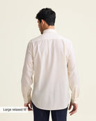 Man wearing a white merinowool dress shirt from in relaxed showing the untucked back of the shirt