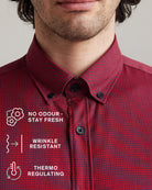 Red checkered merinowool button-down shirt with text and features showing no odour-stay fresh, wrinkle resistant and thermo-regulating on a gray background