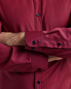 Close-up of a red checkered merino button-down showing the cuffs of the long sleeves