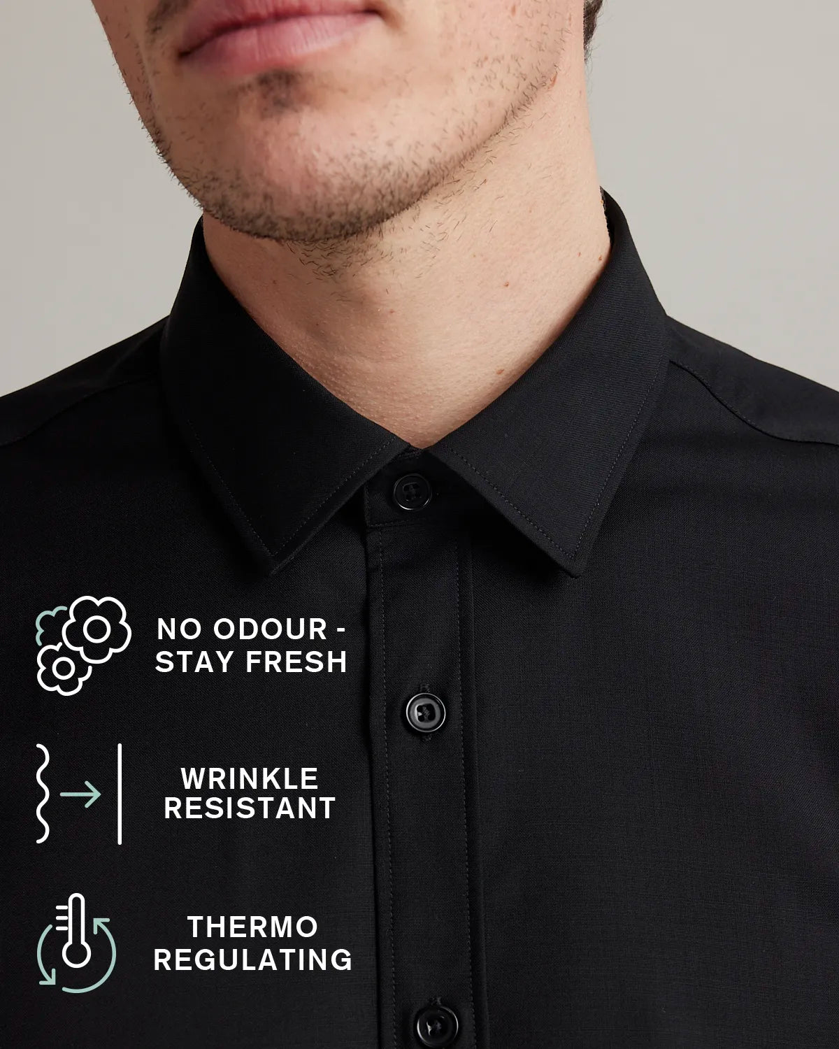Black merino shirt with text and icons detailing features like no odour-stay fresh, wrinkle-resistant and thermo-regulating