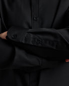 Close-up of a black merinowool shirt with button details
