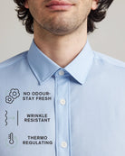 Light blue merino shirt with text indicating features like no odour, stay fresh, wrinkle resistant, and thermo regulating.