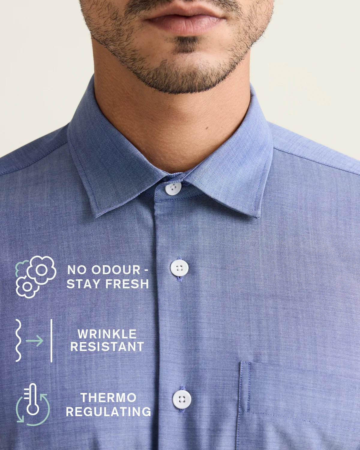 collar detail on a light blue denim merino wool shirt with icons stating no odour-stay fresh, wrinkle resistant and thermo-regulating 
