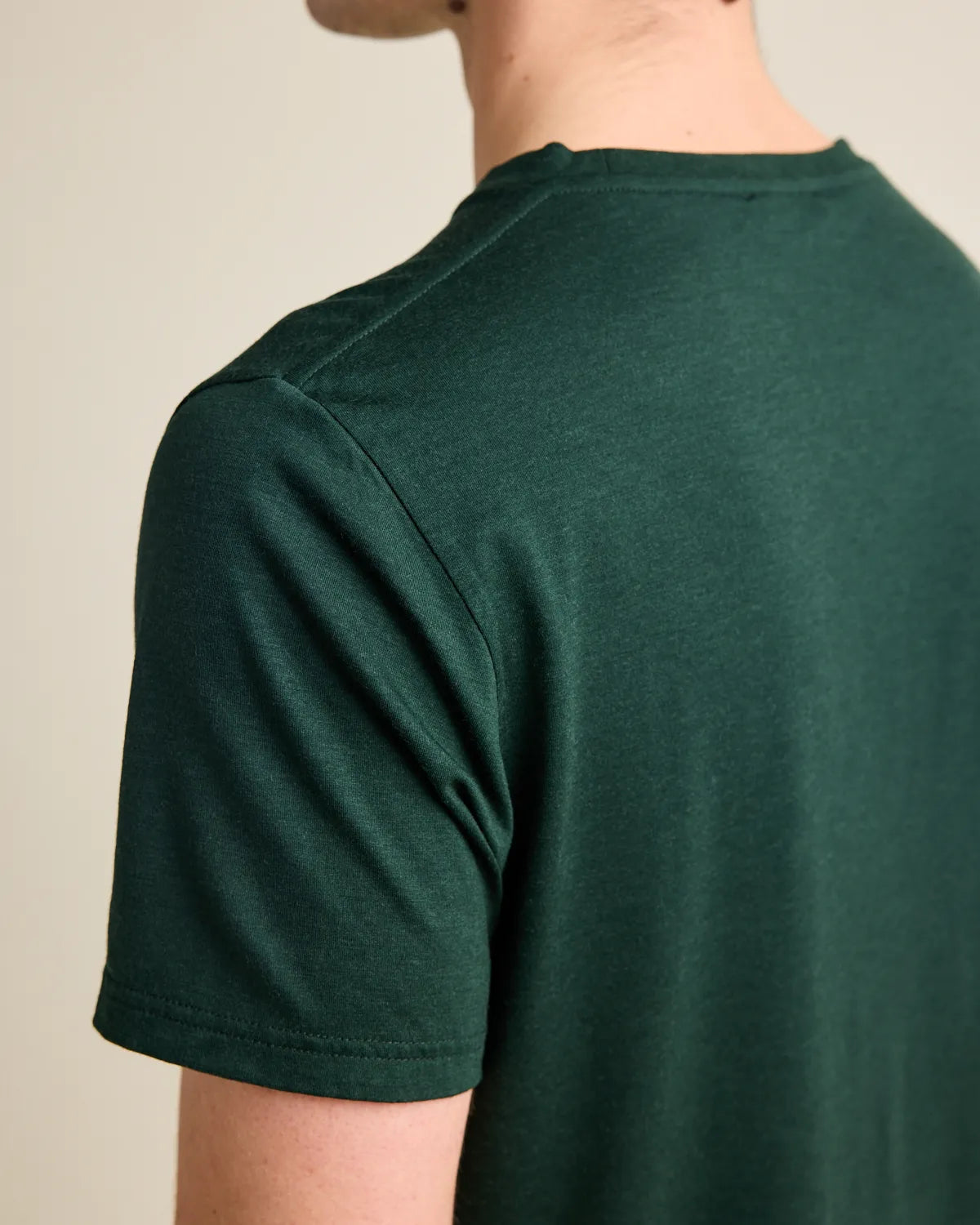 Shoulder detail on a dark green T-shirt