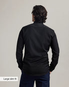 Back view of a person wearing a black merinowool formal shirt with text 'Large slim fit' on a plain background
