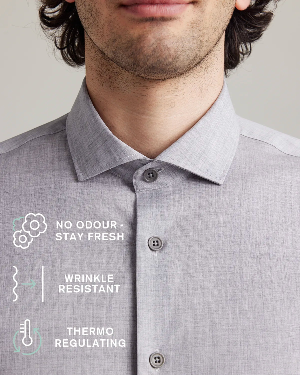Collar detail of a gray merino wool shirt with text highlighting features like no odor, wrinkle resistance, and thermo regulation.